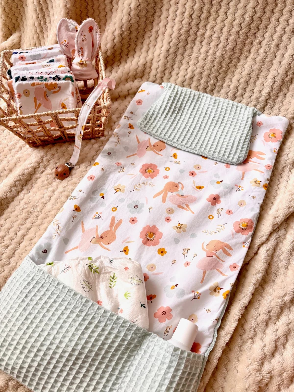 Tapis à langer nomade déplié à motif floral et lapines, avec poches en tissu nid d'abeille vert sauge
